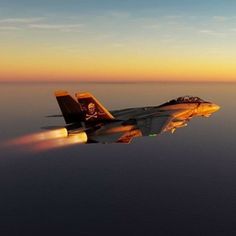 a fighter jet flying through the sky at sunset