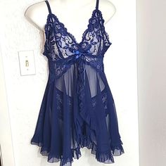 Thisose Babydoll Lacey Sheer Nightgown Set Navy Blue Size Medium Lacey Top Sheer Bottom With Ruffles The Center Opens To Show The Sexy, Lacey, Cheeky Butt Panties The Back Snaps With A Cut-Out Underneath Adjustable Straps No Underneath Approximate Measurements Pit To Pit: 16 Inches Laying Flat Length: 25 Inches From Top Of Lace Blue Sheer Sleep Dresses, Sheer Blue Sleep Dresses, Blue Sheer Lace Sleepwear, Blue Lace Sleepwear For Night, Coquette Blue Summer Sleepwear, Sheer Lace Sleepwear For Sleepover, Sheer Blue Nightgown For Bedtime, Blue Lace Sleeveless Sleepwear, Blue Sleeveless Lace Sleepwear