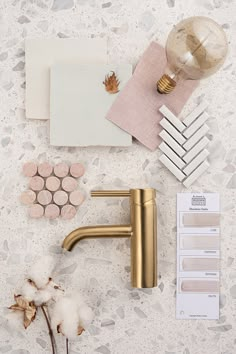 a bathroom sink with gold faucet and accessories