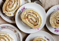 several plates with desserts on them and one has a spiral cake in the middle