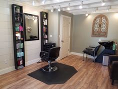 a hair salon with chairs and mirrors