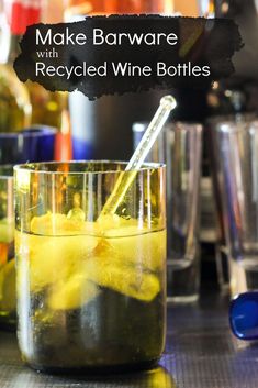 a glass filled with yellow liquid sitting on top of a counter