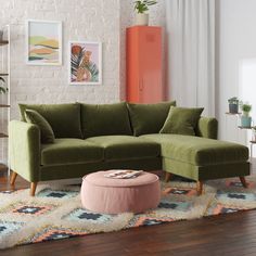 a living room with a green couch and ottoman