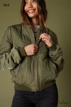 You'll travel in style no matter where you go in the Lulus Style Expedition Olive Green Quilted Bomber Jacket! Woven fabric creates the slick exterior of this padded, quilted jacket, with thick ribbed knit around the cuffs, collar, and waist. Gold zipper at front, plus diagonal front pockets. Utility-style patch on the left sleeve adds a final trendy detail! Fit: This garment fits true to size. Length: Size medium measures 23" from shoulder to hem. Bust: Great for any cup size. Waist: Not Fitted - comfortable room throughout midsection. Fabric: Fabric has no stretch. Fully lined. Shell: 100% Polyester. Contrast: 100% Polyester. Lining: 100% Polyester. Hand Wash Cold. Do Not Bleach. Line Dry. Iron Low Heat. Imported. Lulus | Style Expedition Olive Green Quilted Bomber Jacket | 100% Polyeste Winter Travel Outerwear With Zipper Closure, Spring Travel Fitted Outerwear, Fitted Spring Travel Outerwear, Winter Military Outerwear With Zipper Closure, Military Style Winter Outerwear With Zipper Closure, Military Style Khaki Outerwear With Zipper Closure, Fall Travel Outerwear With Zipper Closure, Quilted Outerwear For Travel In Fall, Quilted Outerwear For Fall Travel