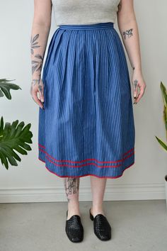 Vintage Blue Striped Pleated Skirt. Red Contrast Trim. Zipper & Button Closure in Back. Lined. 100% Cotton Lining 100% Viscose No Size Tag Excellent Vintage Condition All Measurements Taken Flat Waist-12.5" Hips-27" Length-28" All Sales Are Final. We have taken the time to note all size measurements and the condition of each piece so please look over all the information of the garment you are considering purchasing. Please note that all items are sold in "Vintage Condition". If you have any furt Blue Bottoms With Button Closure For Daywear, Blue Knee-length Bottoms With Button Closure, Blue Midi Skirt For Daywear, Retro Blue Midi Skirt, Vintage Blue Pleated Skirt Bottoms, Vintage Blue Pleated Skirt, Blue Buttoned Skirt, Blue Pleated Daywear Skirt, Vintage Blue Flared Skirt