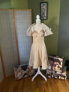 Very cool 1950’s beige formal dress with matching bolero. Both are made of a very heavy fabric. Weird, but the dress and jacket are not the same color, dress is a bit more yellow than jacket. Bolero does not have its buttons. Dress has a sizable water stain on the skirt as well as a couple smaller stains, and the bodice is pretty stained and discolored, likely from sweat?? Definitely needs some TLC, but is totally structurally sound and unique. Being sold as isWomen’s size smallDressBust: 35”Wai Elegant Vintage Evening Dress For Spring, Chic Fitted Vintage Wedding Dress, Elegant Beige Vintage Dress For Evening, Beige Evening Dress With Lined Bodice, Beige Evening Dresses With Lined Bodice, Cream Vintage Dress For Spring Party, Spring Vintage Fitted Evening Dress, Spring Beige Dresses With Lined Bodice, Chic Fitted Vintage Dress In Beige