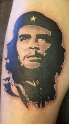 a man's arm with a portrait of che guevan on the side