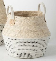 two woven baskets with handles on white background