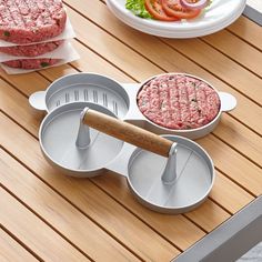 hamburger patties and burger cutters on a wooden table