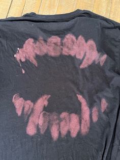 a black shirt with pink ink on it