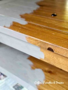 a wooden table with white paint on it