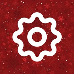 a red background with white snowflakes and a circular object in the center that says o