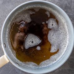 a pot filled with liquid sitting on top of a table