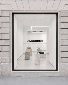 a store window with the words jil sander on it