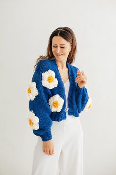 "Flower cardigan bomber jacket. Meet bloom knit jacket super fluffy, chunky knit cardigan! Unique designed long sleeves with flowers. There are large fluffy knitted flowers on the cardigan. When placing an order, you can choose the main color for the sweater and also choose the color for the flowers (these can be white and yellow flowers as in the photo or multi-colored knitted flowers). Oversized sweater would look perfect as part of your look. Hand knitted cardigan can be worn as casual coat f Trendy Blue Acrylic Outerwear, Trendy Blue Sweater Coat For Spring, Oversized Blue Acrylic Outerwear, Cozy Knitted Cardigan For Spring, Spring Chunky Knit Acrylic Sweater Coat, Cozy Chunky Knit Spring Outerwear, Blue Trendy Acrylic Cardigan, Trendy Blue Acrylic Cardigan, Blue Knitted Cardigan For Spring