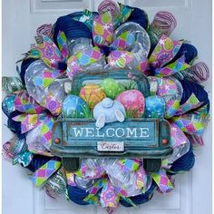 a welcome sign on the front door of a house decorated with colorful ribbons and balloons