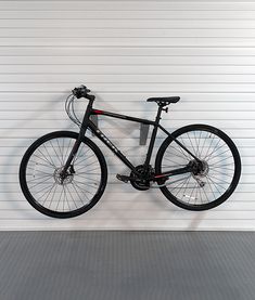 a bicycle is mounted to the wall in front of a garage