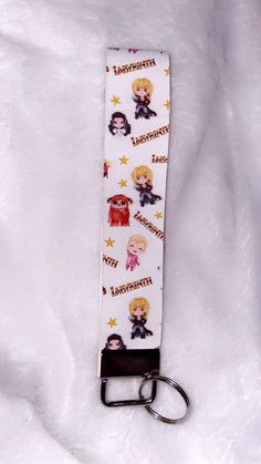 the lanyard strap is decorated with pictures of different characters and names on white fabric