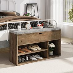 a bed sitting next to a dresser with shoes on it