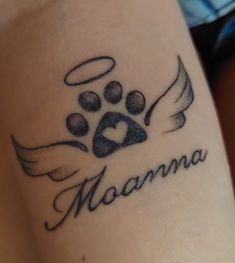 a tattoo on the arm of a woman with a dog paw and name in it