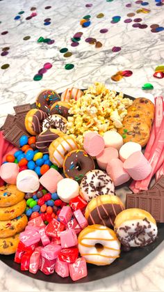 a plate full of assorted donuts and candy