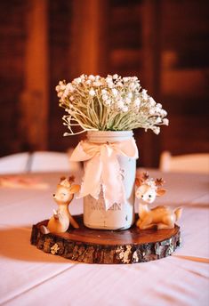 a mason jar filled with baby's breath sitting on top of a table