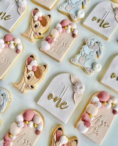 decorated cookies are arranged in the shape of baby's first names and other items