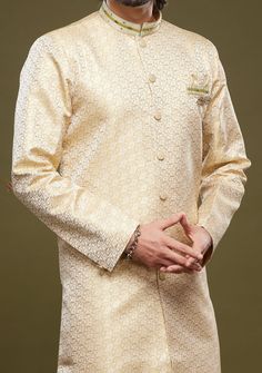 Ready-Made Sherwani With Aligarhi Trouser. All Over Jacquard Brocade Style Fabric Top. Art Silk Aligarhi Ready Made Trouser. Crafted in Chinese Collar Neck, and Full Sleeve. Satin Lining with Plain Work. High-Quality Matching Buttons. Please Note: The footwear shown in the picture is for presentation and photography purpose only. Color: There might be slight color variation due to lightings and flashes while photo shooting. The color may also vary because of different screen resolutions. Wash Ca Semi-stitched Gold Kurta With Naqshi Detailing, Long Sleeve Lawn Suit With Pallu For Eid, Elegant Long Sleeve Kurta With Zari Weaving, Traditional Ceremonial Sherwani With Zari Weaving, Traditional Gold Lawn Suit With Pallu, Long Sleeve Sherwani With Zari Weaving, Formal Brocade Saree Set, Fitted Bandhgala With Zari Weaving For Festivals, Transitional Long Sleeve Sherwani With Zari Weaving