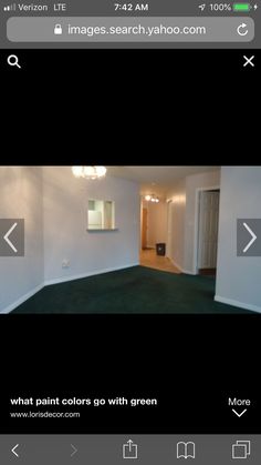 an empty room with green carpet and white walls