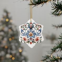 a ceramic ornament hanging from a christmas tree