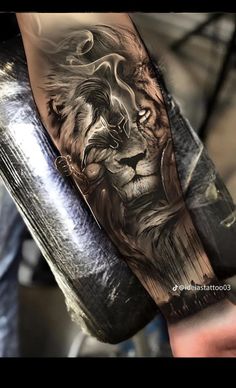 a man's arm with a lion tattoo on it