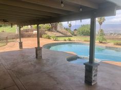 an outdoor swimming pool and covered patio area