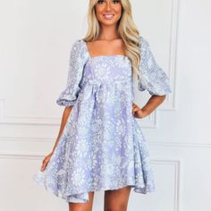 Such A Cute Fit White Dress With Purple Flowers, Purple Puff Sleeve Mini Dress For Spring, Lavender Sundress For Garden Party, Lavender Floral Print Sundress, Lavender Floral Print Cotton Dress, Lavender Dress For Summer Garden Party, Spring Beach Lavender Dress, Lavender Cotton Dress With Floral Print, Lavender Floral Print Mini Dress