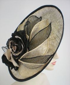 What's not to love about this black and gold dramatic fascinator hat for women? It's a large disc (16 inches across) made with a shiny gold metallic sinamay and accented with hand rolled leaves in black and gold, and handmade silk flowers in black and light beige. It sits at a dramatic angle on the head for maximum style. A group of hand rolled leaves swoop over the head on the underside of the fascinator. Make an entrance no one will forget at Kentucky Derby, Ascot, Church, or Ladies tea. A spe Elegant Gold Top Hat For Royal Ascot, Elegant Gold Top Hat For Church, Gold Wide Brim Costume Hat For Parties, Fitted Gold Hat With Flat Brim, Elegant Gold Top Hat For Party, Elegant Gold Top Hat With Wide Brim, Chic Gold Hat For Kentucky Derby, Gold Brimmed Mini Hat For Royal Ascot, Gold Brimmed Mini Hats For Church