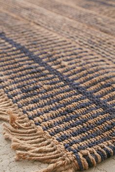 a blue and brown rug on the ground