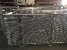 an industrial metal work bench in a warehouse or factory with lots of steel mesh covering it