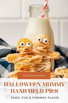 two cookies with googly eyes are stacked on top of each other in front of a bottle of milk