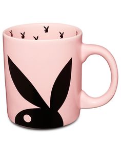 a pink coffee mug with black bunny ears on it