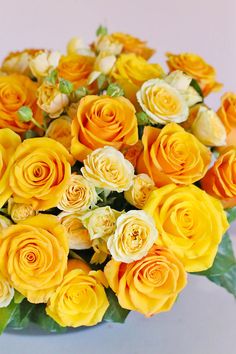 a bouquet of yellow and white roses