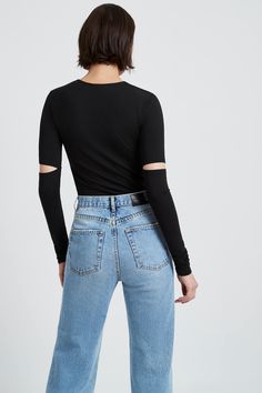 No, long sleeves don't have to be boring. Cue our Indra Top, featuring a new take on the traditional sleeve with unique slits above each elbow. Edgy and casual at once, she's your choice for memorable everyday wear in high-stretch, sustainable European jersey.[SPLIT] Julia, in black, is 5’10” (178 cm), wearing size XS. Total length approximately 26.5" (67.5 cm) Sustainable European Jersey (96% Tencel, 4% Elastane). Machine wash or hand wash in cold water, and lay flat to dry. Do not tumble dry. Long Sleeve Fitted Top, Edgy Tops, Traditional Sleeve, Cutout Top, Fitted Turtleneck, Extra Long Sleeves, Sweatshirt Fabric, Cut Out Top, Fitted Top