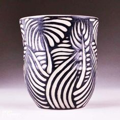 a black and white striped cup sitting on top of a table