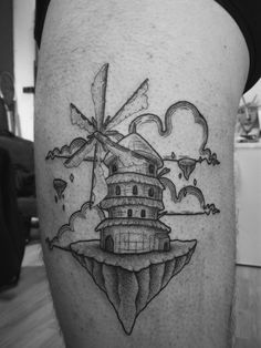 a black and white photo of a lighthouse tattoo