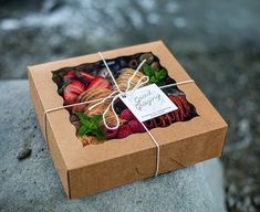 the box is wrapped in brown paper and tied with a string that has fruit on it