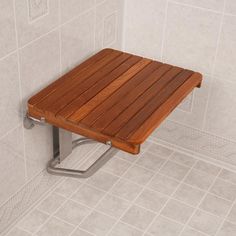 a wooden shower seat in the corner of a bathroom