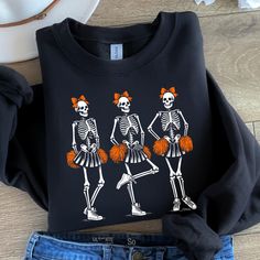 Cheerleader Skeletons, Cheer Skeleton, Cheer Sweatshirt, Cheer Mom Shirt, Cheer Coach Shirt, Halloween Shirt, Spooky Season,  Dark Memecore, Dark Clowncore, Spooky Shirt, Scary Shirt, Goth Shirt Ideal for any situation, a unisex heavy blend crewneck sweatshirt is pure comfort. These garments are made from polyester and cotton. This combination helps designs come out looking fresh and beautiful. The collar is ribbed knit, so it retains its shape even after washing. There are no itchy side seams o Black Sweatshirt For Cheerleading In Fall, Cheer Coach Shirts, Cheer Mom Shirt, Coach Shirt, Cheer Shirt, Cheer Mom Shirts, Cheer Coach, Goth Shirt, Pom Pom Girl