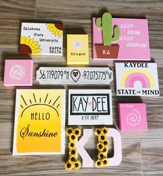 several different magnets and stickers on a wooden floor with cactus, sunflower