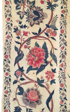 an old rug with flowers and birds on it's border, in the shape of a flower