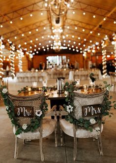 two chairs with flowers and greenery sit in front of each other on the floor