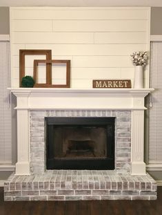 a fireplace with a sign that says market on it and some pictures above the fire place