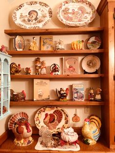 there are many turkey plates on the shelves in this room with other thanksgiving decorations and figurines